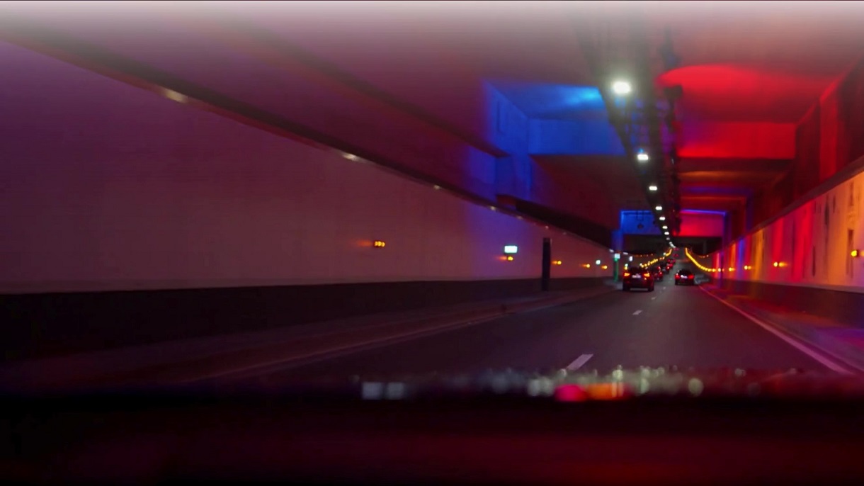 Featured in Hogan Lovells' AI Trends Guide, this image represents the journey and innovation in AI technology, law, and compliance. This image shows driving through an illuminated tunnel with vibrant blue and red lights