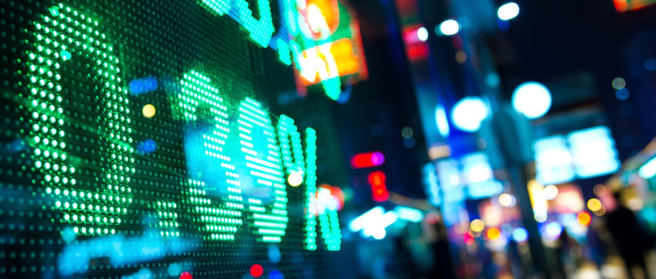 Display of stock market charts in a street at night